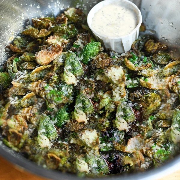 Brussels leaves tossed with Truffle Oil, Parmesan & Chives. Served with Truffle Aioli.